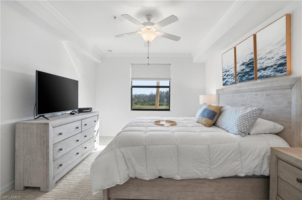 9578 Trevi Court, Unit 5124 Naples, FL 34113 - Photo 11 of 40 a bedroom with a bed and a flat screen tv