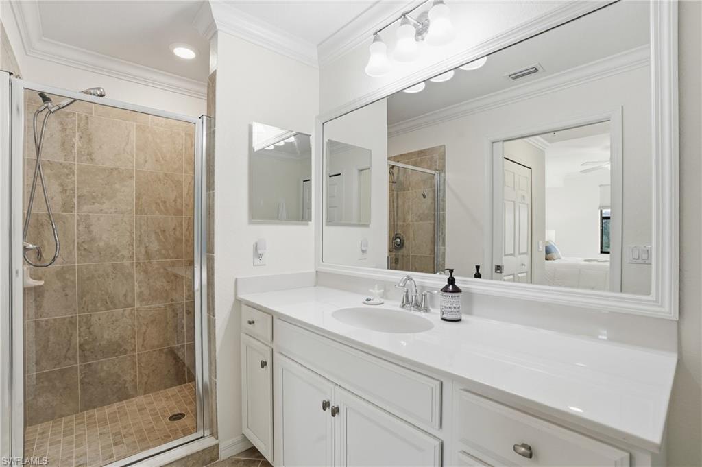 9578 Trevi Court, Unit 5124 Naples, FL 34113 - Photo 12 of 40 a bathroom with a shower sink and mirror