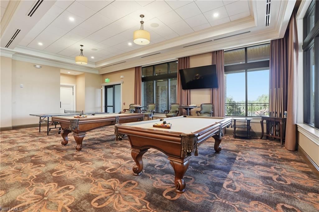 9578 Trevi Court, Unit 5124 Naples, FL 34113 - Photo 30 of 40 a room with pool table flat screen tv and windows
