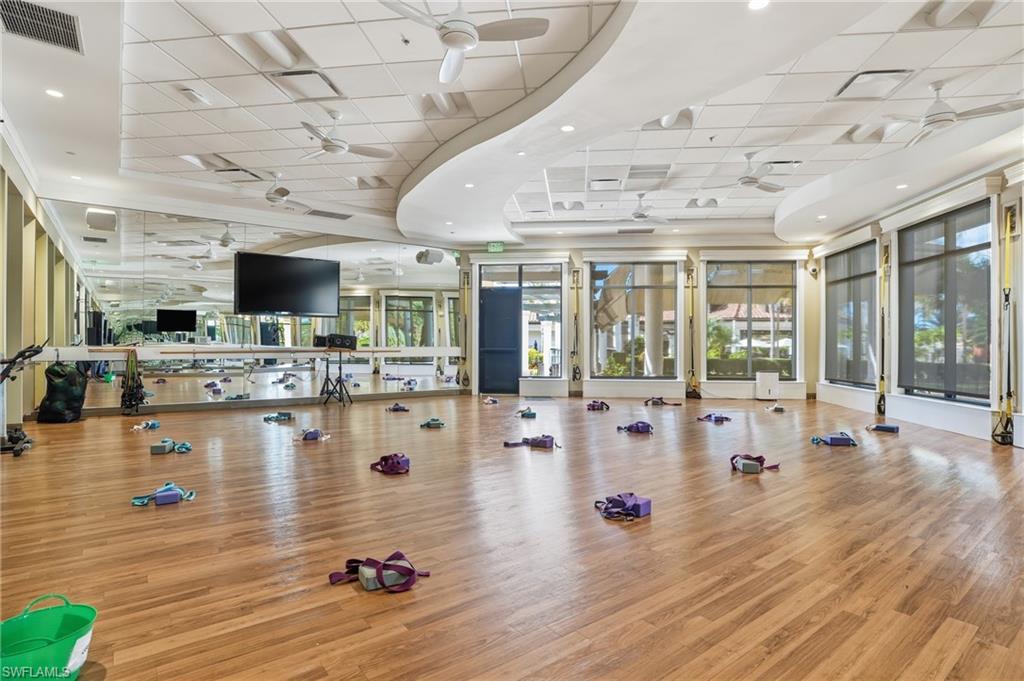 9578 Trevi Court, Unit 5124 Naples, FL 34113 - Photo 32 of 40 a living room with lots of furniture and kitchen view