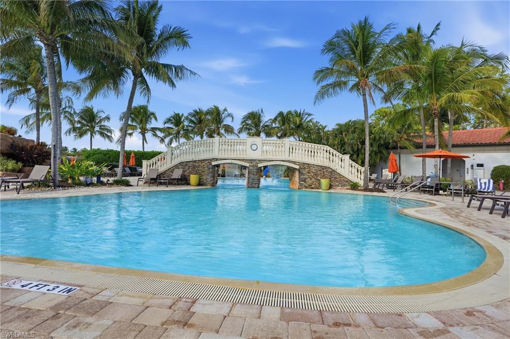 9578 Trevi Court, Unit 5124 Naples, FL 34113 - Photo 38 of 40 a view of a swimming pool with a table and chairs