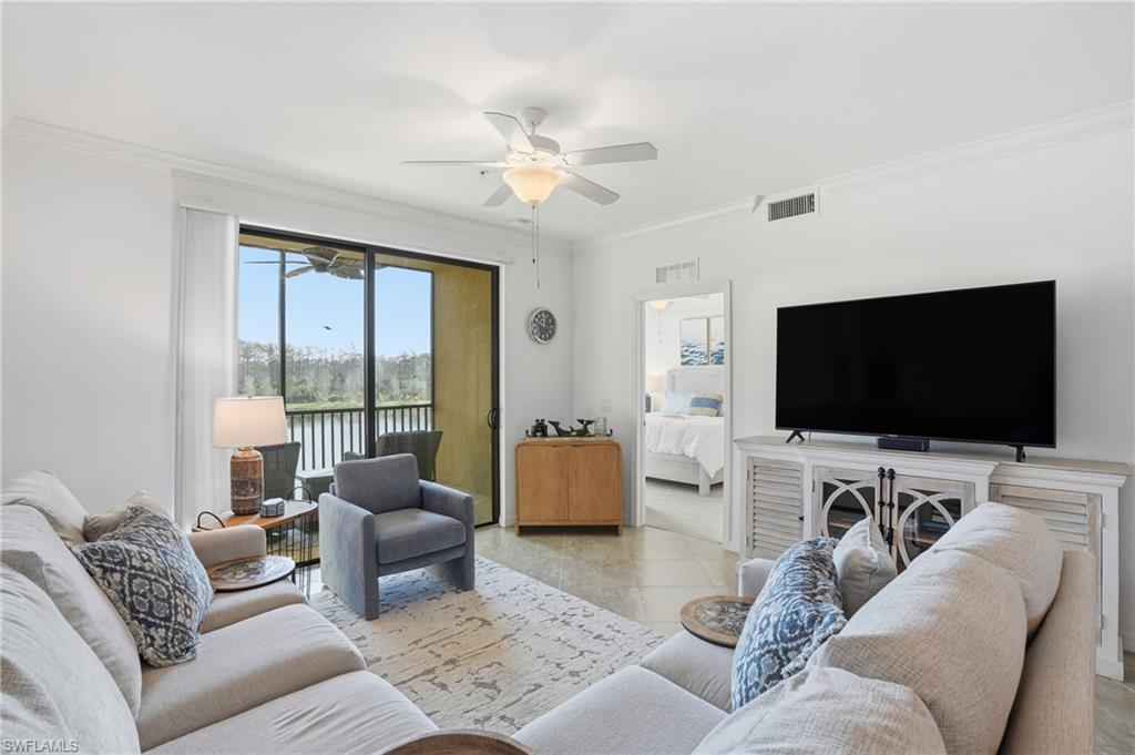 9578 Trevi Court, Unit 5124 Naples, FL 34113 - Photo 4 of 40 a living room with furniture and a flat screen tv