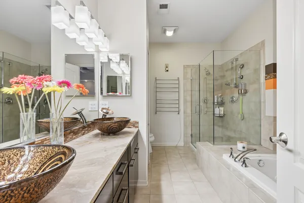 a bathroom with a tub sink and mirror