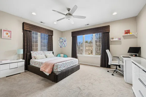 a bedroom with a large bed and a desk
