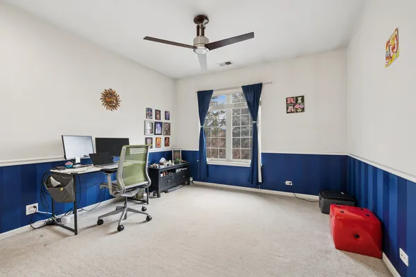 a livingroom with workspace and a window