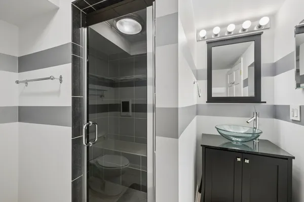 a bathroom with a sink vanity and a mirror