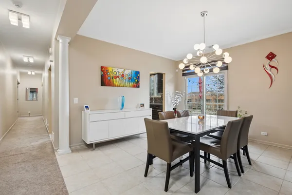 a view of a dining room with furniture and chandelier