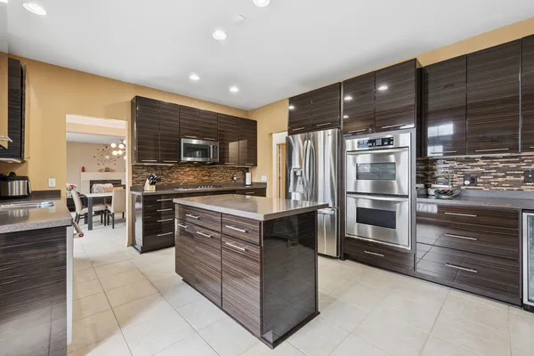 a kitchen with stainless steel appliances granite countertop a stove and a refrigerator