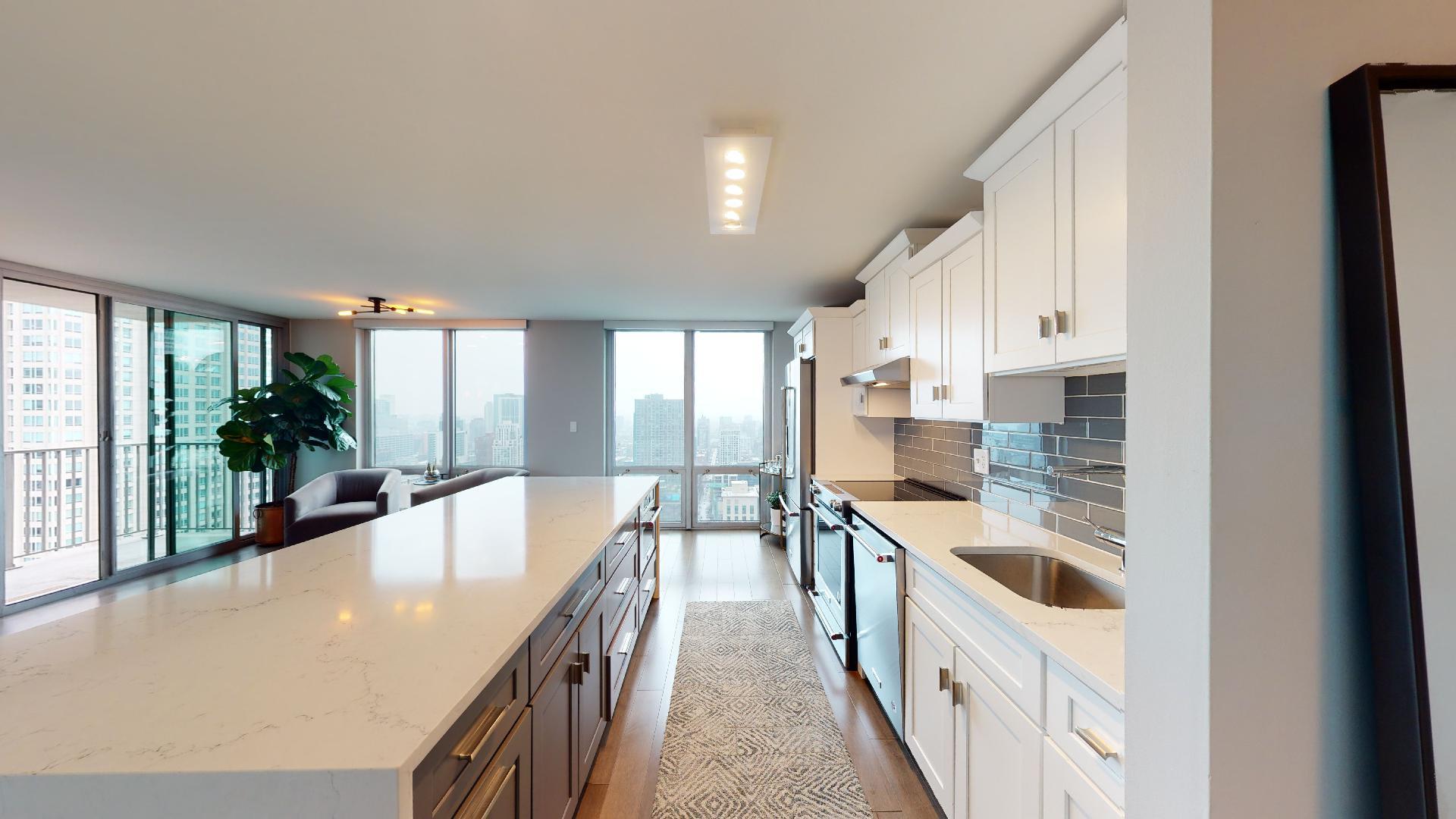 2 East Erie Street, Unit 3605 Chicago, IL 60611 - Photo 13 of 30 a large kitchen with stainless steel appliances granite countertop a lot of counter space and a large window