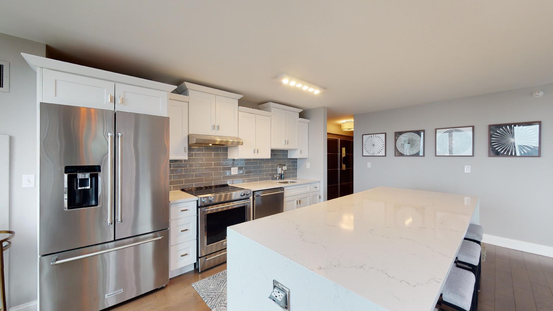 2 East Erie Street, Unit 3605 Chicago, IL 60611 - Photo 14 of 30 a kitchen with stainless steel appliances a refrigerator sink and stove