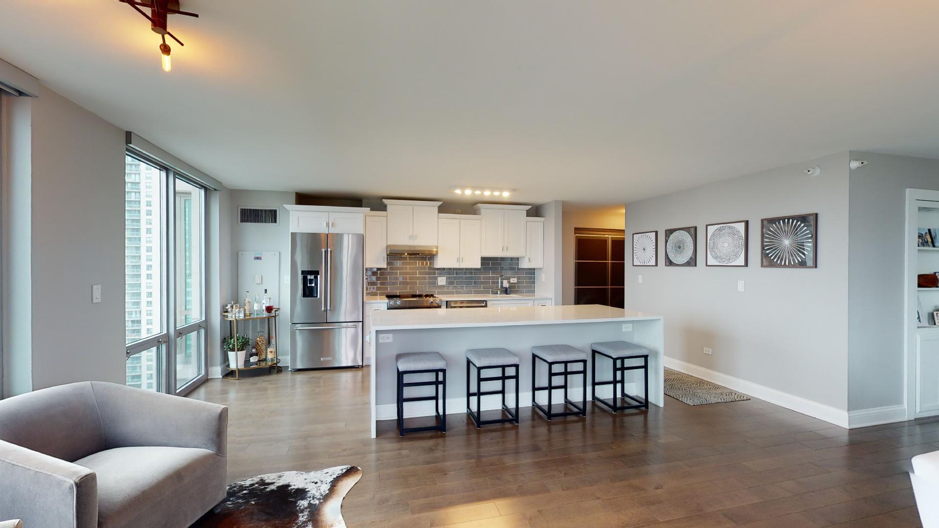 2 East Erie Street, Unit 3605 Chicago, IL 60611 - Photo 17 of 30 a living room with stainless steel appliances kitchen island granite countertop furniture and a large window