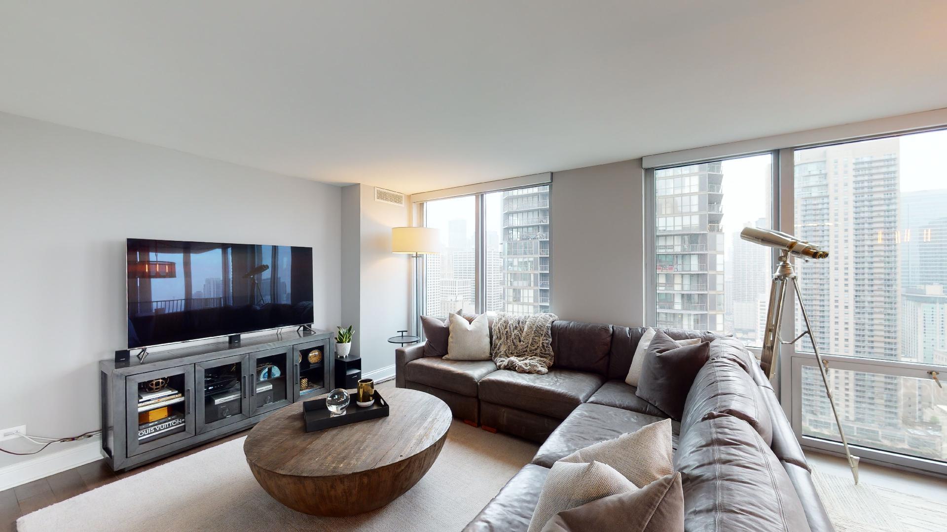 2 East Erie Street, Unit 3605 Chicago, IL 60611 - Photo 3 of 30 a living room with furniture and a flat screen tv