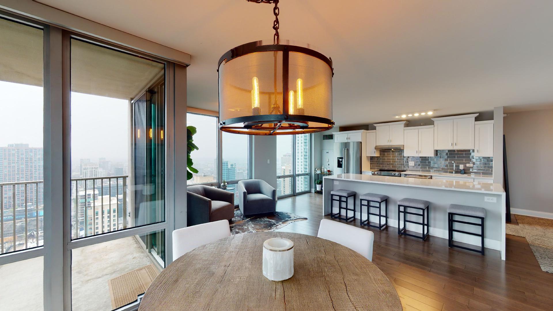 2 East Erie Street, Unit 3605 Chicago, IL 60611 - Photo 5 of 30 a dining room with furniture wooden floor a chandelier