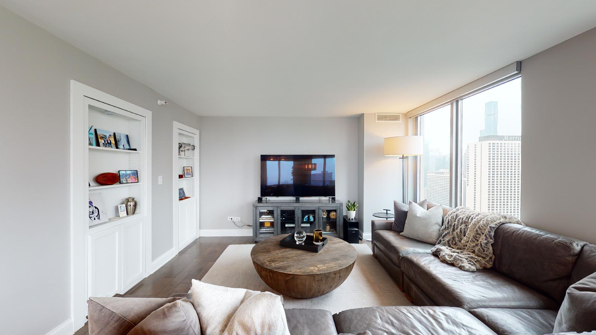 2 East Erie Street, Unit 3605 Chicago, IL 60611 - Photo 6 of 30 a living room with furniture and a flat screen tv