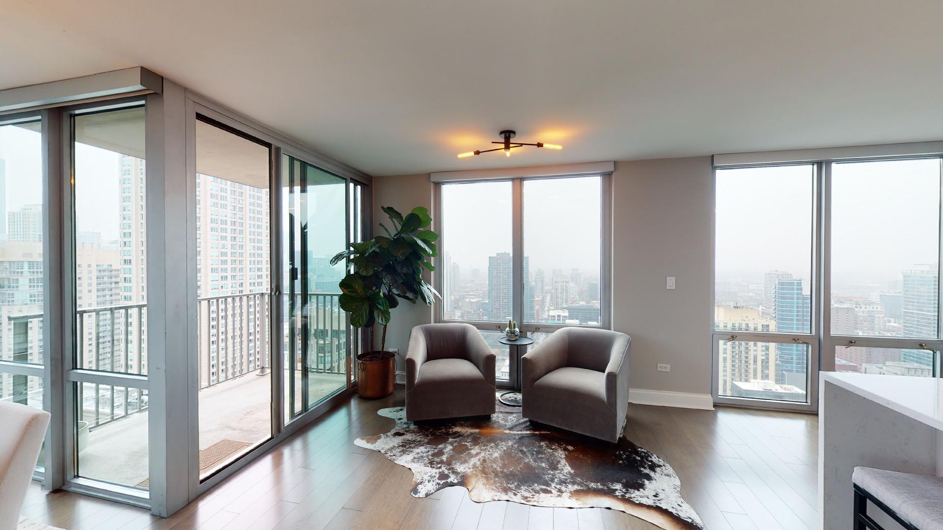 2 East Erie Street, Unit 3605 Chicago, IL 60611 - Photo 10 of 30 a living room with furniture and a floor to ceiling window