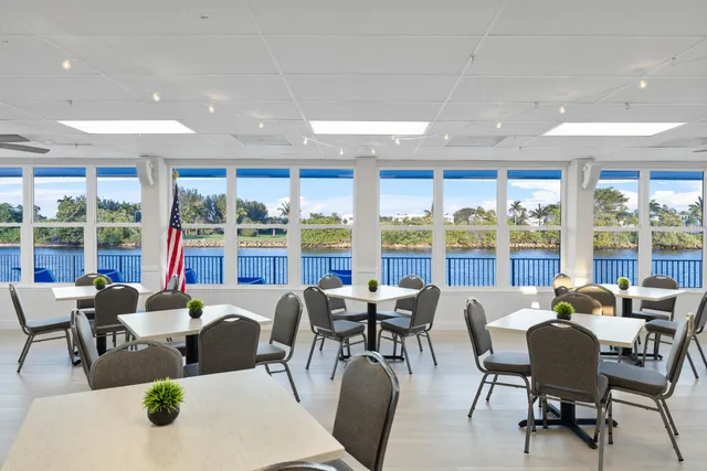 a dining room with furniture a large window and a table