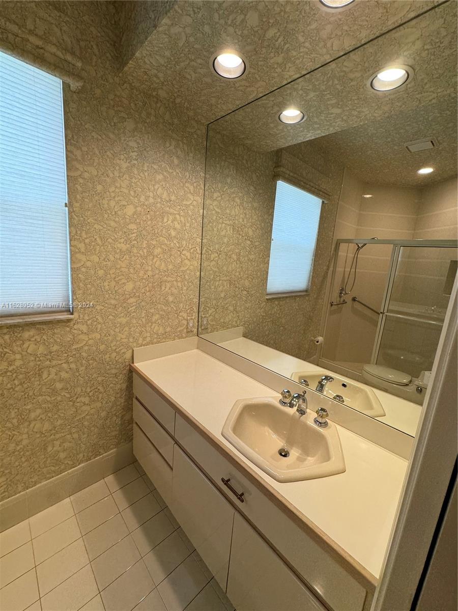 2743 Pinehurst Drive Weston, FL 33332 - Photo 11 of 35 a bathroom with a sink and a mirror