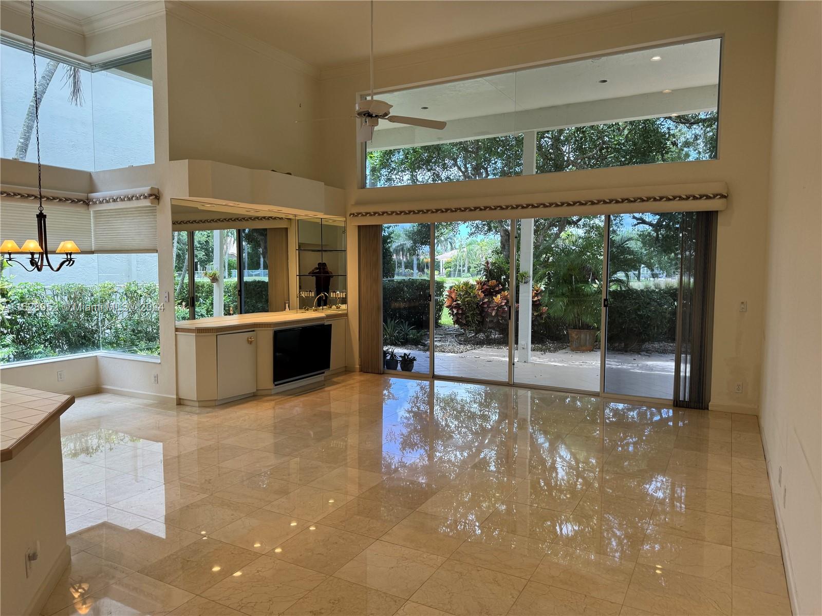 2743 Pinehurst Drive Weston, FL 33332 - Photo 14 of 35 a view of a porch with chairs and floor to ceiling window