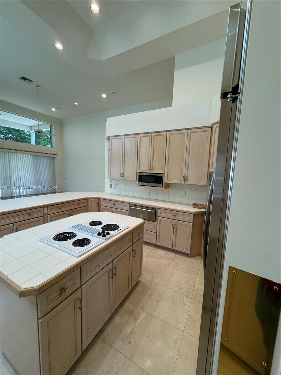 2743 Pinehurst Drive Weston, FL 33332 - Photo 17 of 35 a kitchen with a stove a sink and a refrigerator