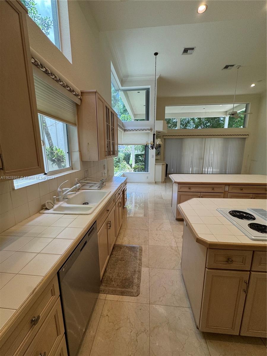 2743 Pinehurst Drive Weston, FL 33332 - Photo 18 of 35 a kitchen with a stove sink and cabinets
