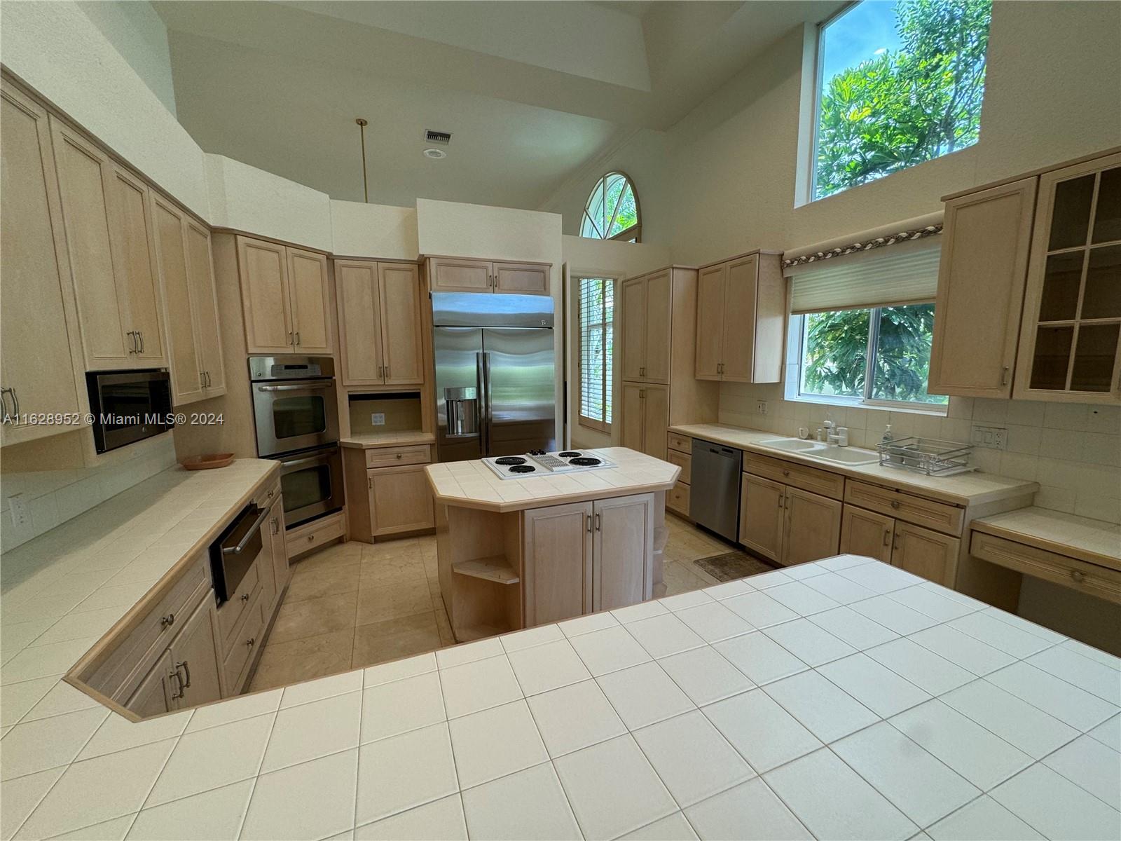 2743 Pinehurst Drive Weston, FL 33332 - Photo 19 of 35 a kitchen with a sink and chairs