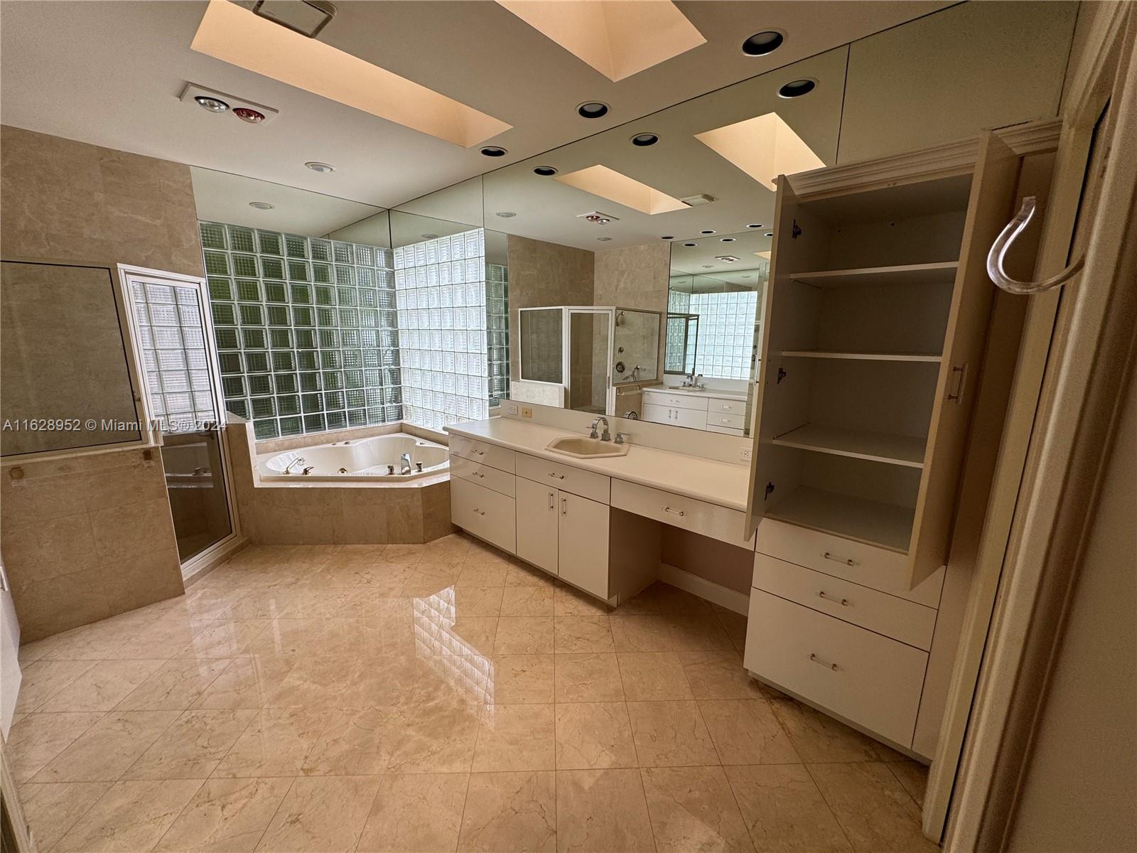 2743 Pinehurst Drive Weston, FL 33332 - Photo 23 of 35 a bathroom with a double vanity sink a mirror and a bathtub