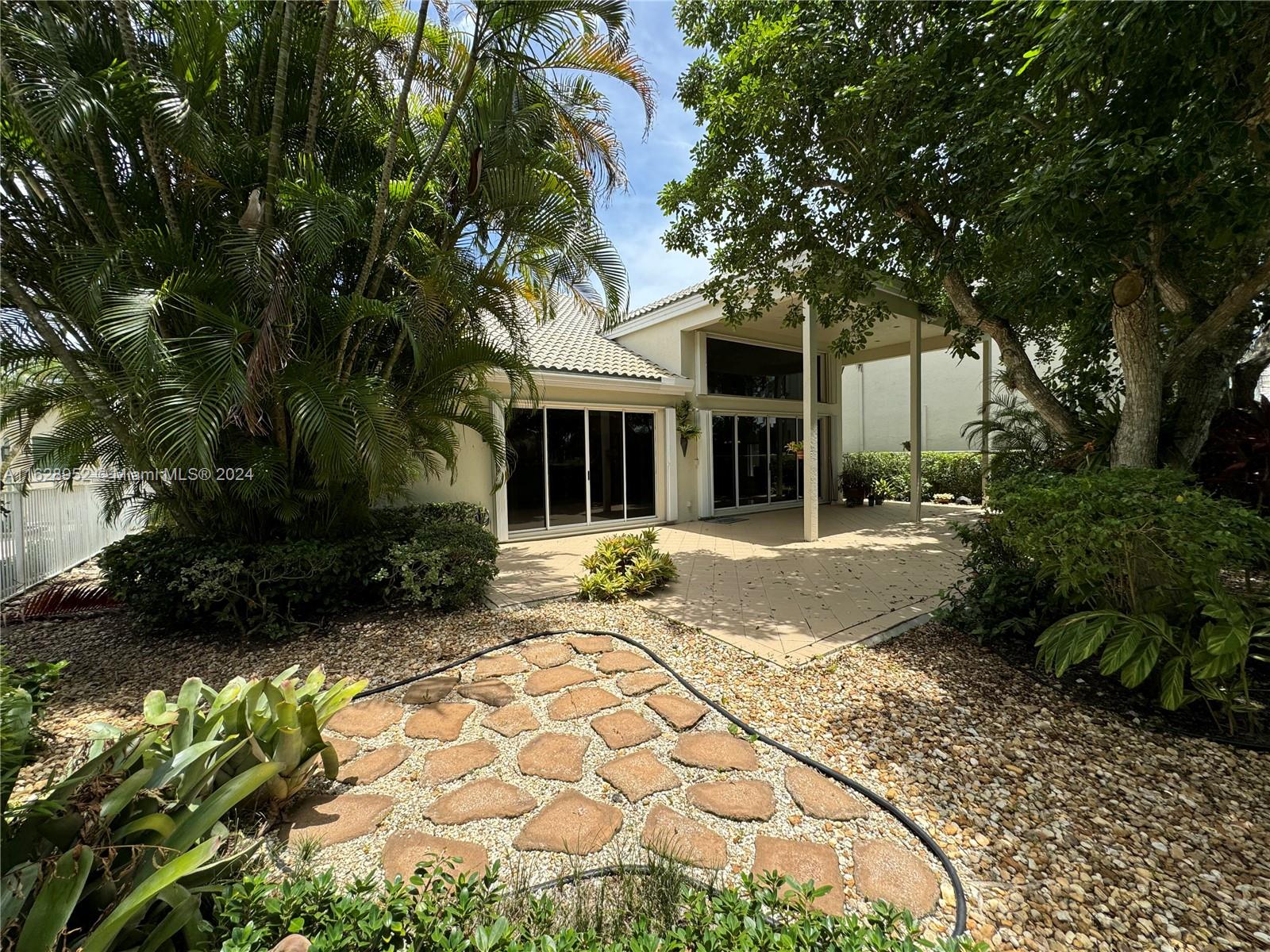2743 Pinehurst Drive Weston, FL 33332 - Photo 26 of 35 a front view of a house with a garden
