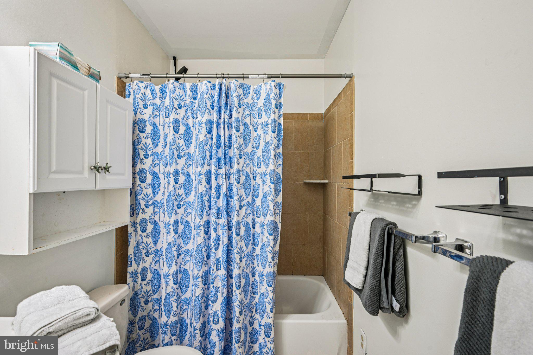 13 Tarnsfield Road Westampton, NJ 08060 - Photo 22 of 44 a bathroom with a shower curtain and a toilet