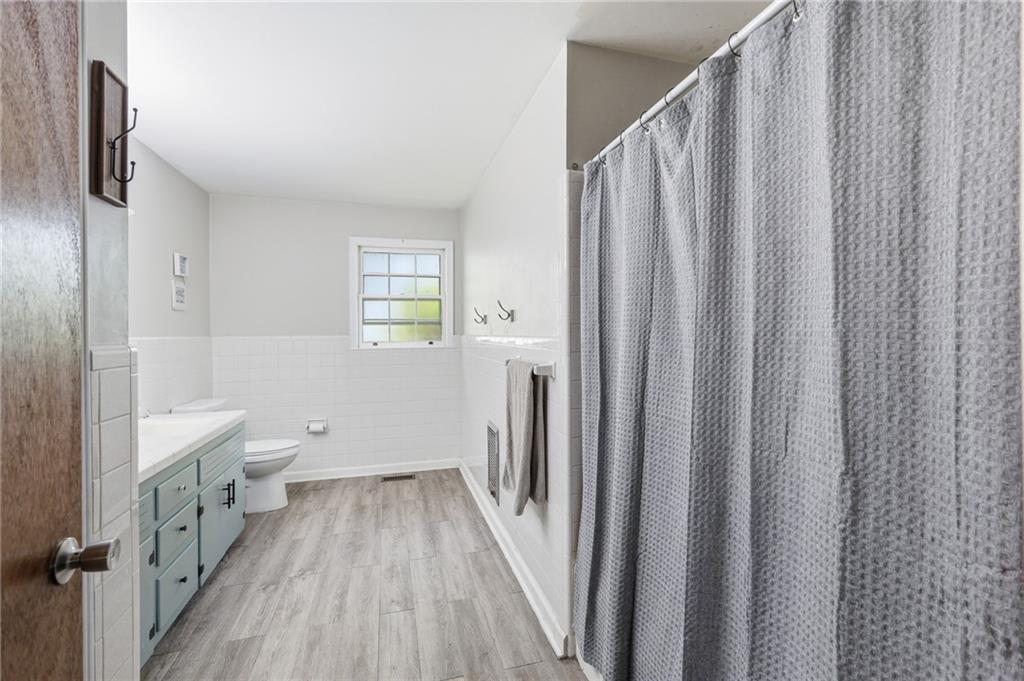 570 Wildcat Bridge Road Royston, GA 30662 - Photo 19 of 29 a bathroom with a sink a toilet and shower