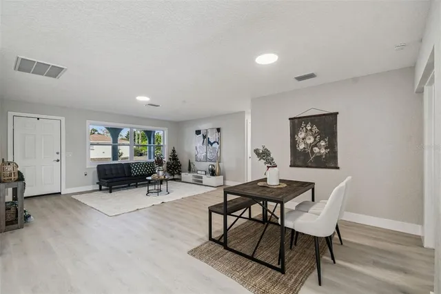 a dining room with furniture and wooden floor