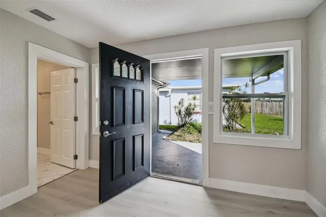 a view of an empty room and wooden floor