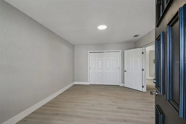 a view of a room with wooden floor and window