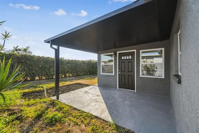 an aerial view of a house with a swimming pool outdoor seating and yard