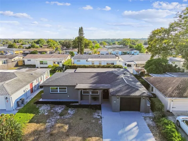 an aerial view of a house with a yard pool outdoor seating and city view