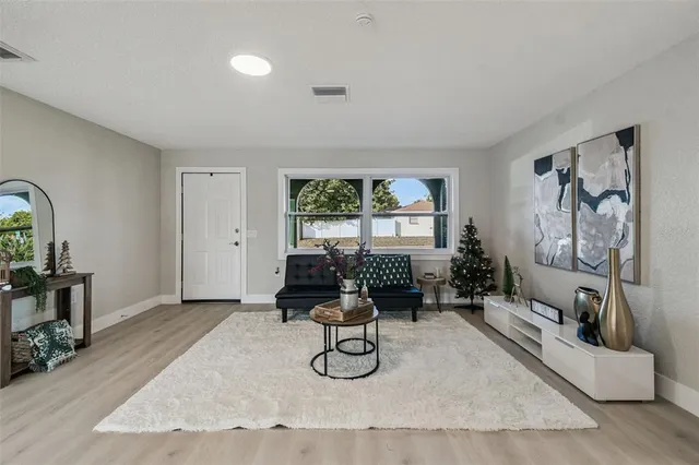 a living room with furniture window and wooden floor