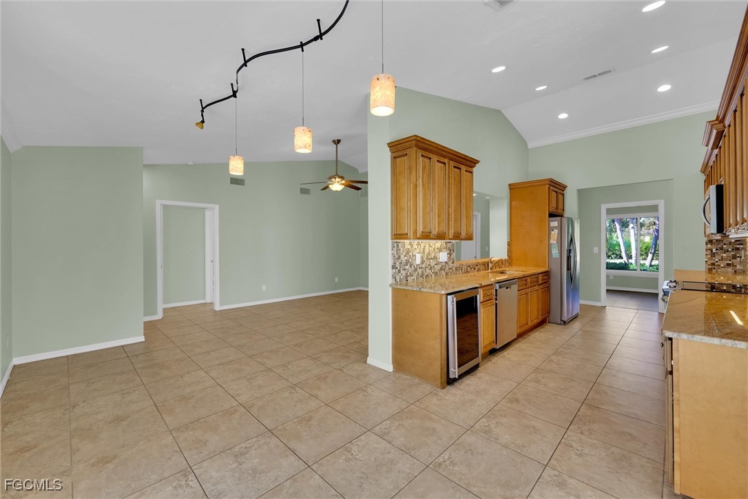 17040 Pleasure Road Cape Coral, FL 33909 - Photo 13 of 38 a large kitchen with stainless steel appliances a large counter top and a stove