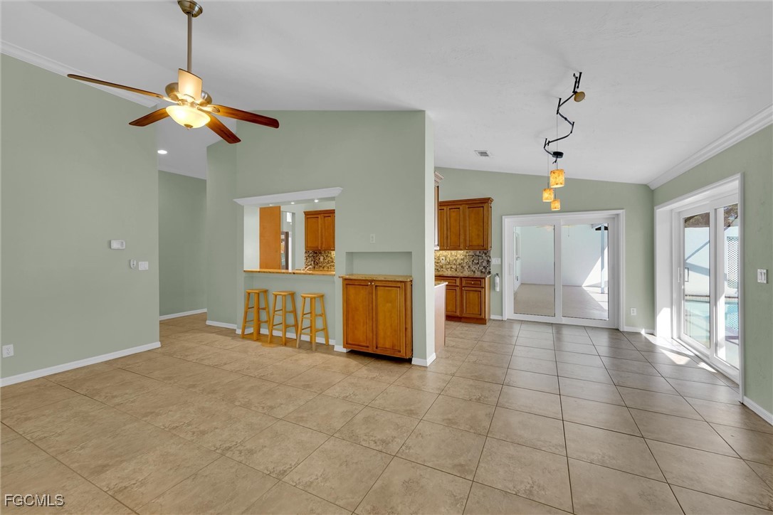 17040 Pleasure Road Cape Coral, FL 33909 - Photo 14 of 38 a view of a room with a chandelier fan and windows