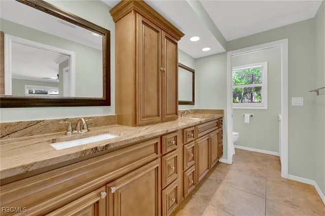 a spacious bathroom with a double vanity sink and a mirror