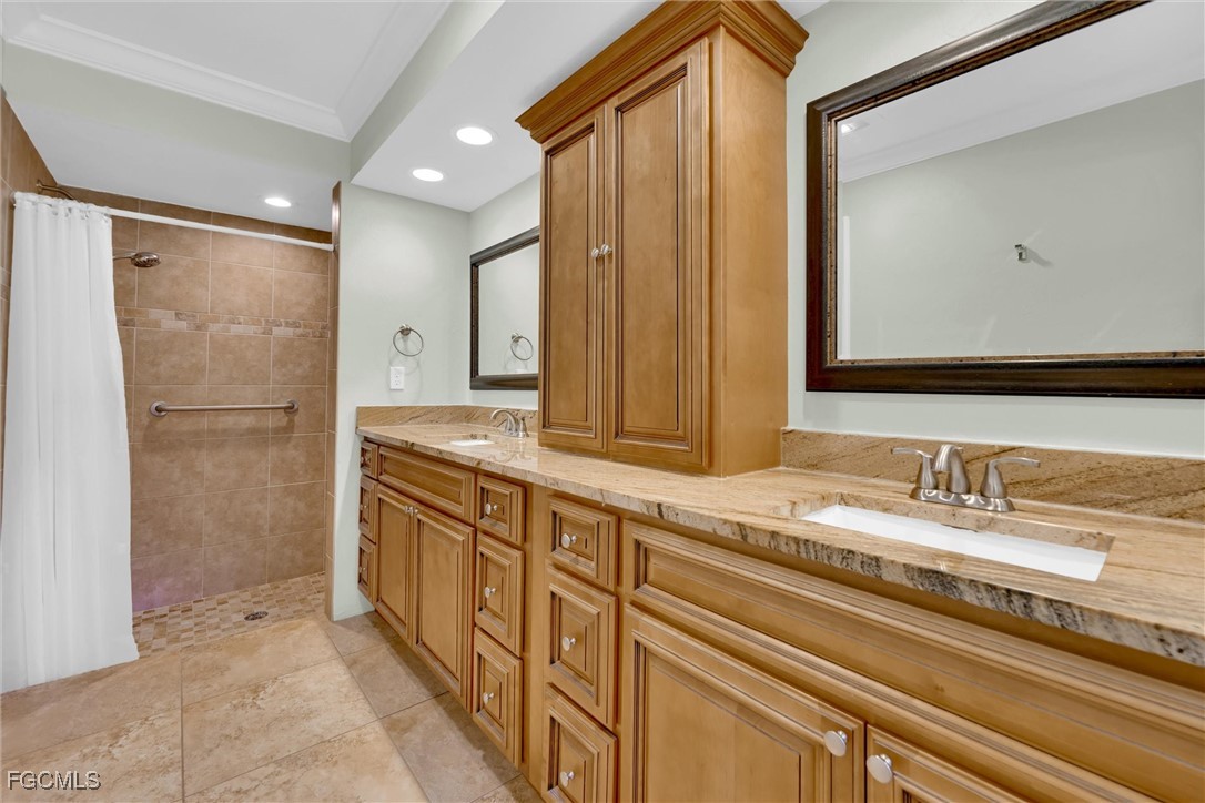 17040 Pleasure Road Cape Coral, FL 33909 - Photo 19 of 38 a bathroom with a double vanity sink and a mirror
