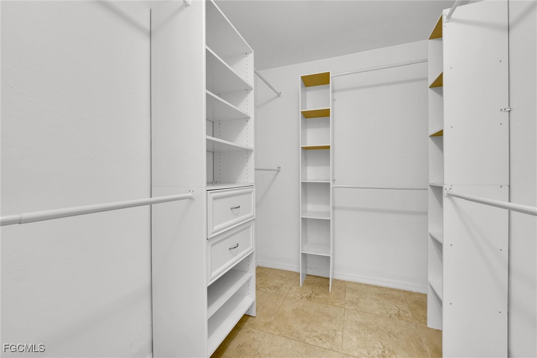17040 Pleasure Road Cape Coral, FL 33909 - Photo 20 of 38 a view of walk in closet with empty racks