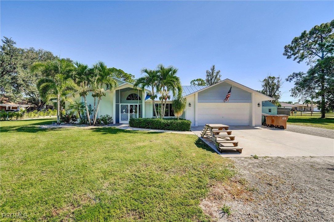 17040 Pleasure Road Cape Coral, FL 33909 - Photo 2 of 38 a front view of a house with garden