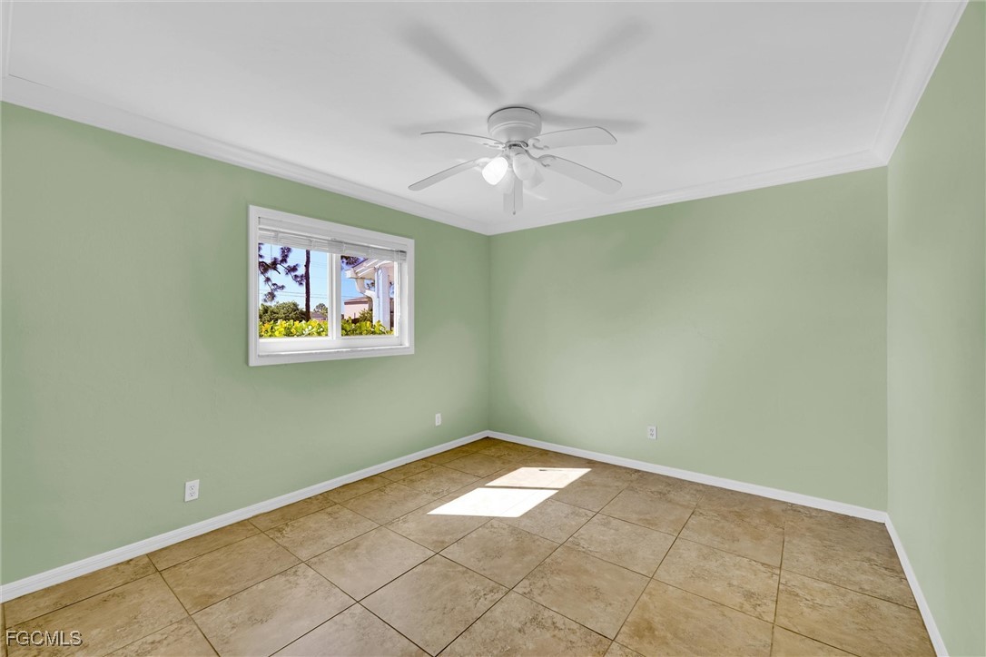17040 Pleasure Road Cape Coral, FL 33909 - Photo 21 of 38 an empty room with a window and ceiling fan