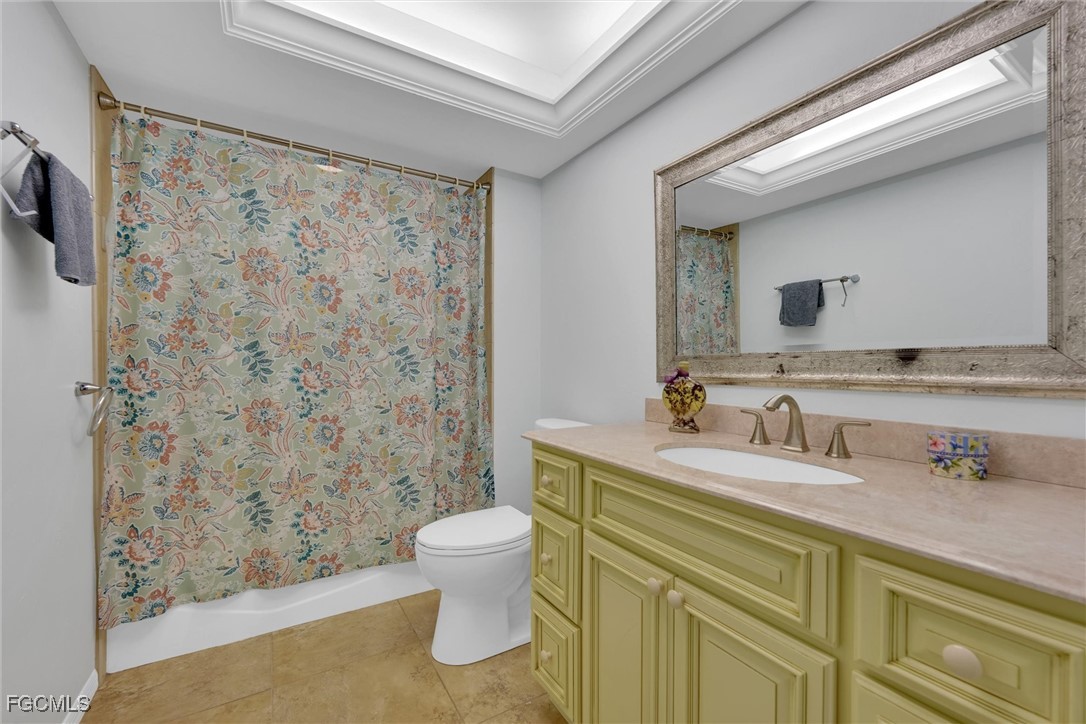 17040 Pleasure Road Cape Coral, FL 33909 - Photo 25 of 38 a bathroom with a sink a toilet and a mirror