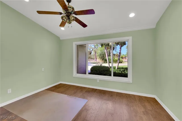 a view of room with window ceiling fan and hardwood floor