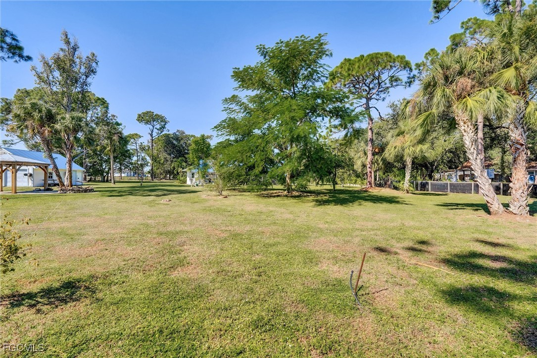 17040 Pleasure Road Cape Coral, FL 33909 - Photo 36 of 38 a swimming pool with outdoor seating and yard