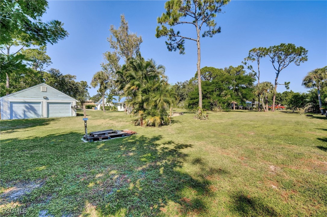17040 Pleasure Road Cape Coral, FL 33909 - Photo 37 of 38 a view of a house with a yard