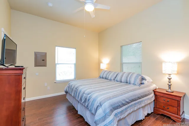 a bedroom with a bed and a flat tv screen on a dresser