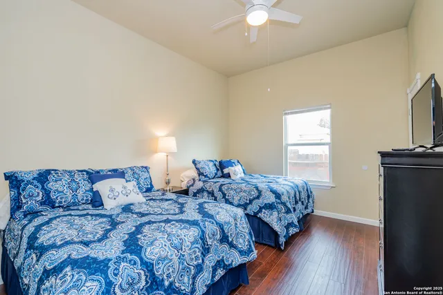 a bedroom with two beds and a chandelier