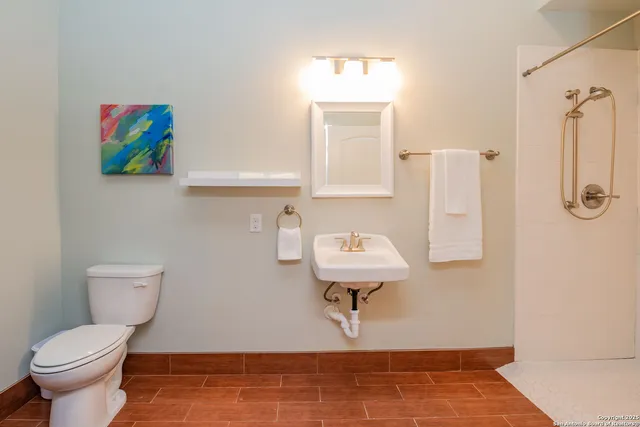 a bathroom with a toilet sink and mirror