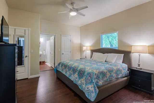 a bedroom with bed and wooden floor